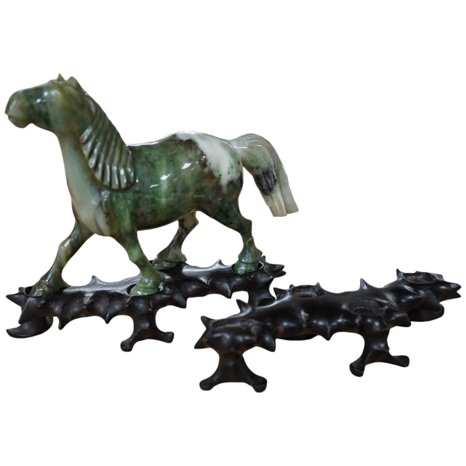 A pair of mid 20th century Chinese jadeite figures of horses, raised on hardwood stands, 13cm wide. Condition - fair, two legs broken and re-glued